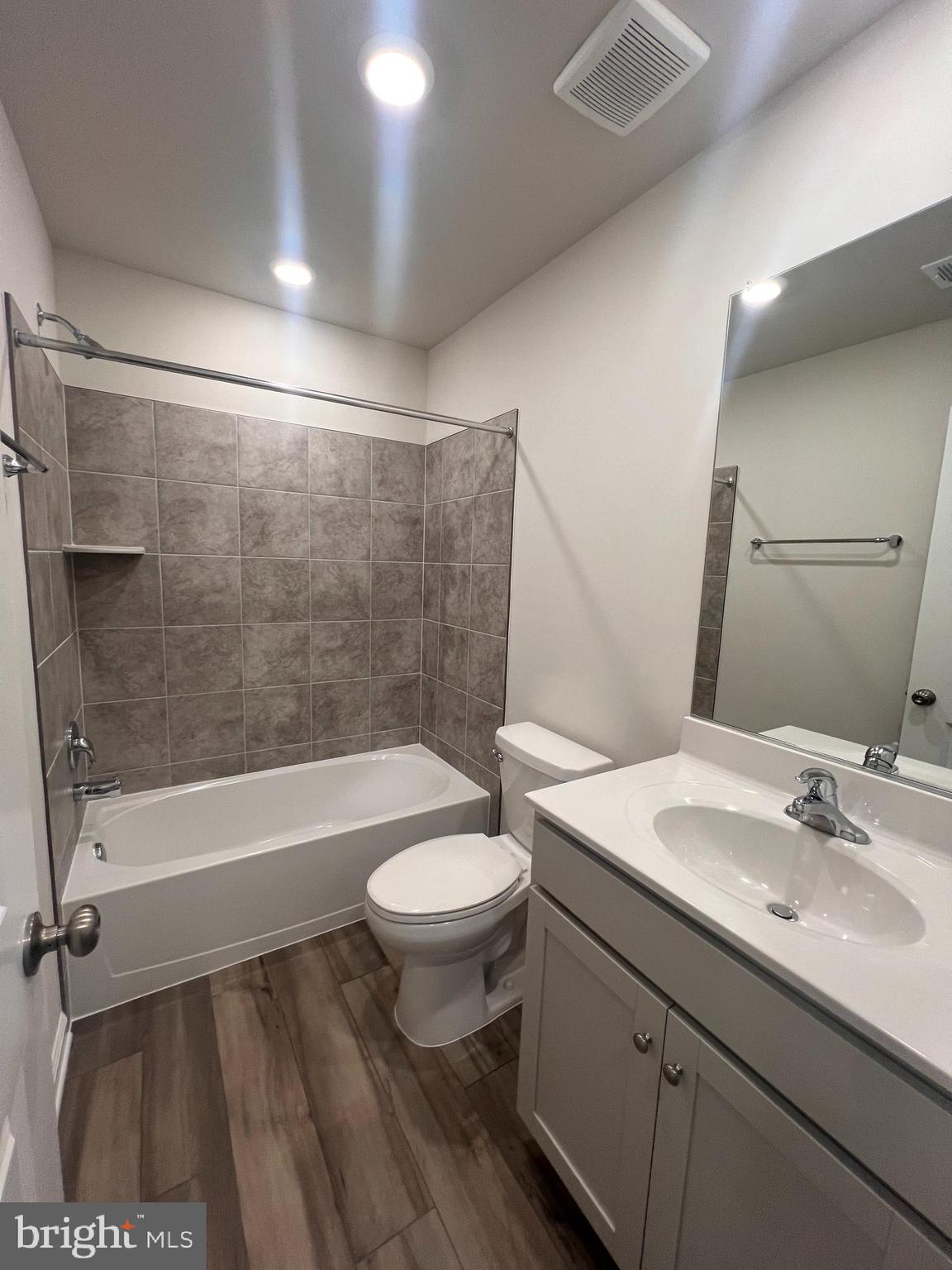 311 Sandy Btm Circle Ranson, WV 25438 - Photo 31 of 33 a bathroom with a sink a toilet a mirror and bathtub