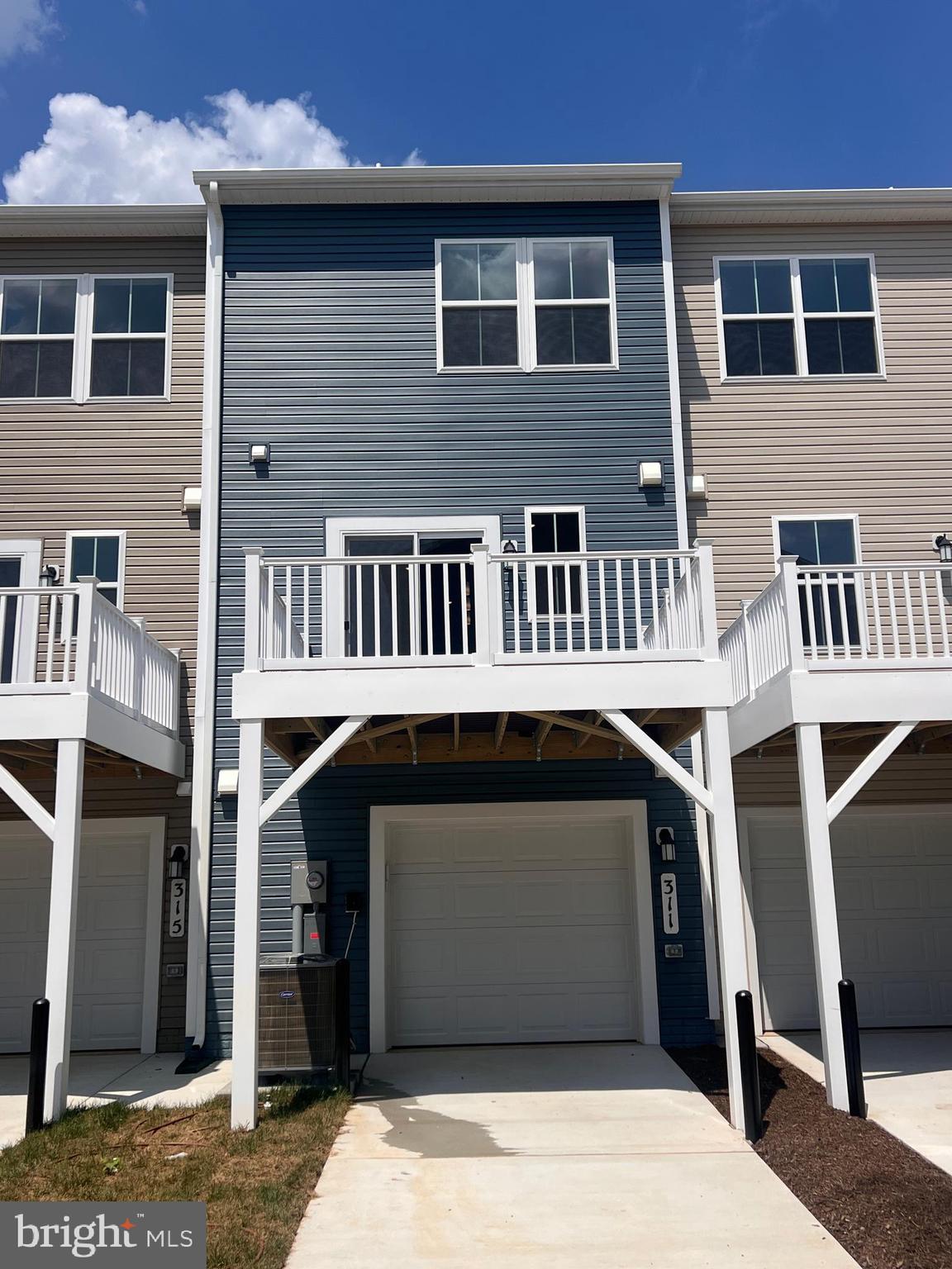 311 Sandy Btm Circle Ranson, WV 25438 - Photo 4 of 33 a front view of a house with a garage