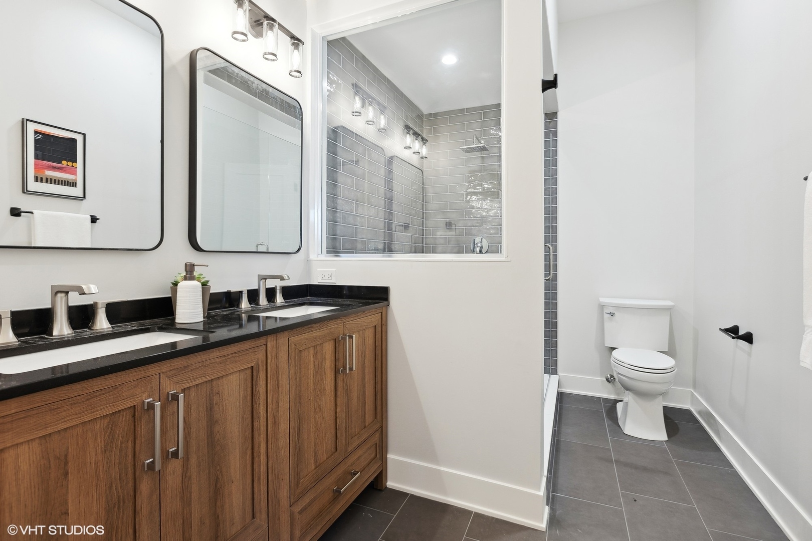 3414 North Tripp Avenue Chicago, IL 60641 - Photo 21 of 38 a bathroom with double vanity sink a toilet and a mirror