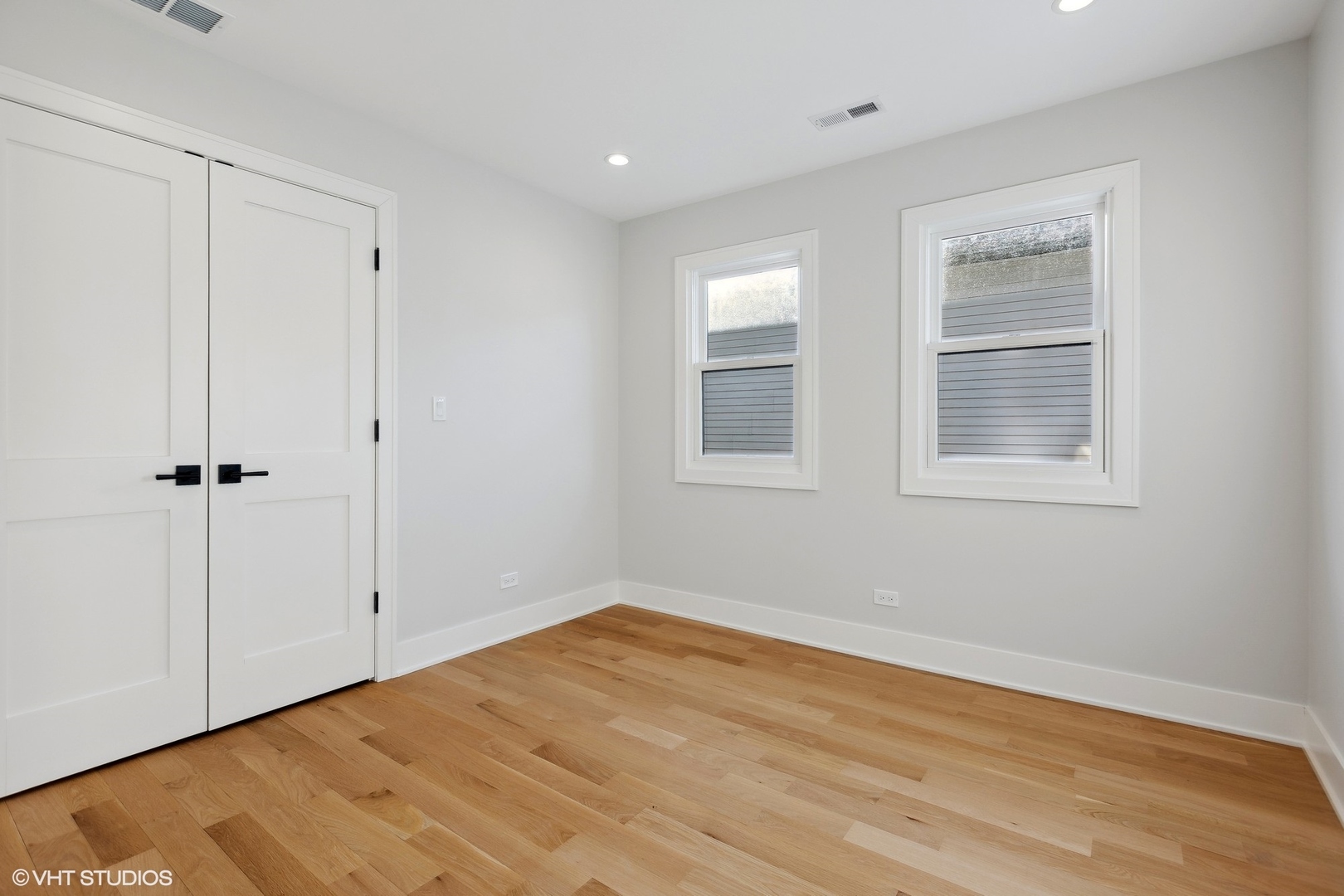 3414 North Tripp Avenue Chicago, IL 60641 - Photo 23 of 38 a view of an empty room with wooden floor and a window