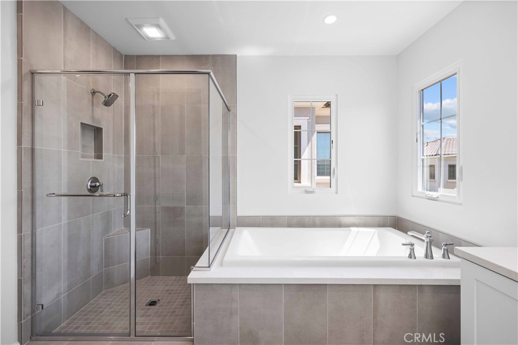 220 Fiore Irvine, CA 92602 - Photo 23 of 26 a bathroom with a bathtub and a shower