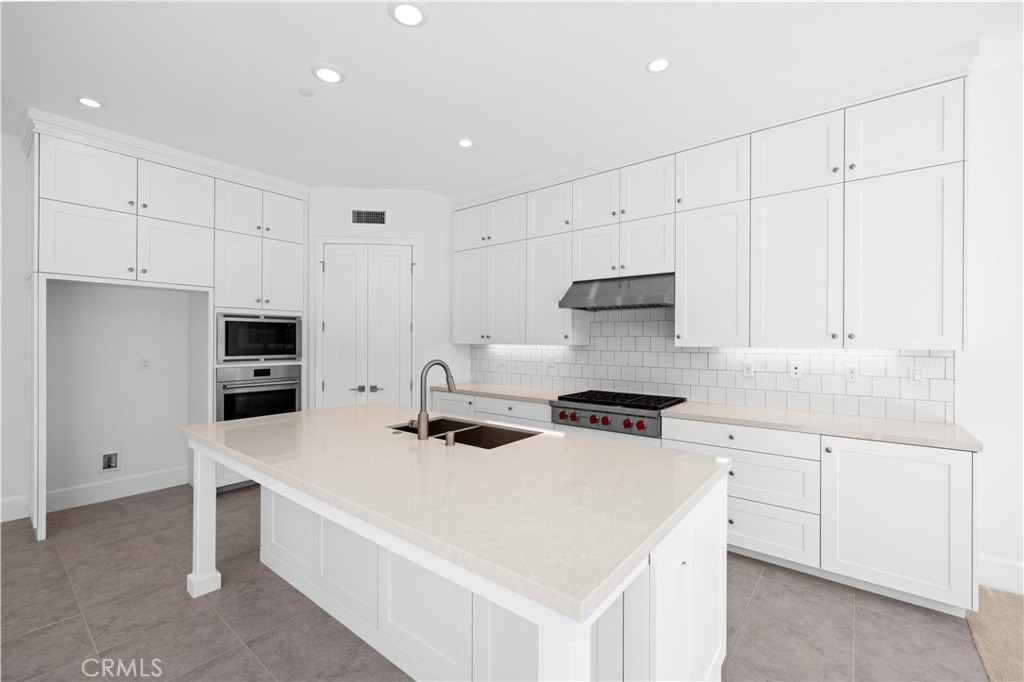 220 Fiore Irvine, CA 92602 - Photo 5 of 26 a kitchen with a stove a sink and a refrigerator