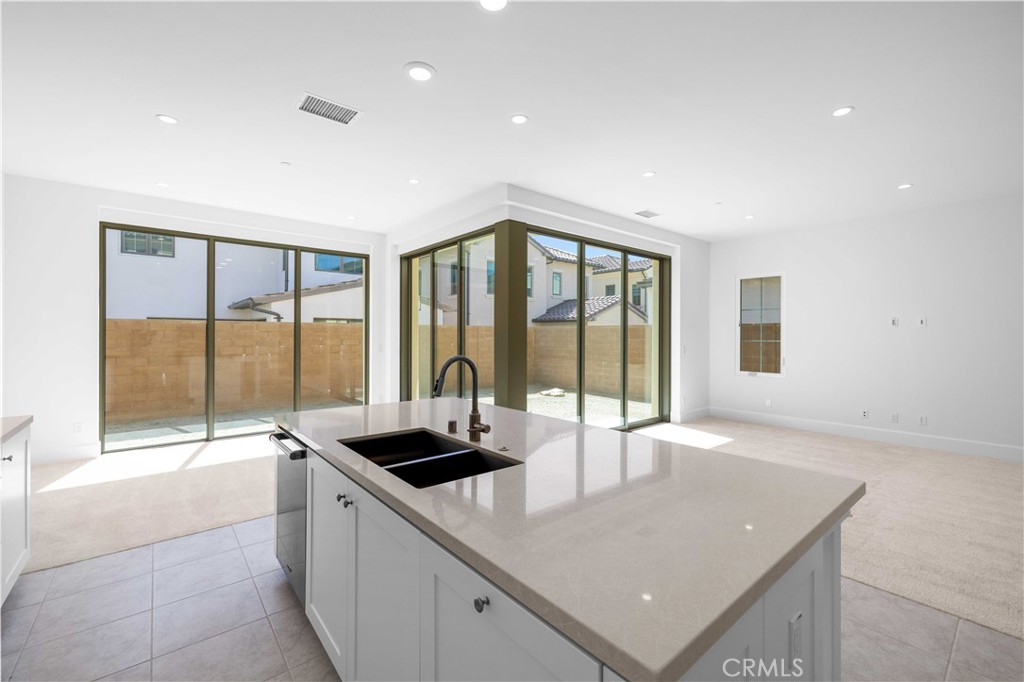 220 Fiore Irvine, CA 92602 - Photo 7 of 26 a kitchen with a sink and large window