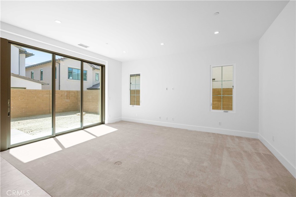 220 Fiore Irvine, CA 92602 - Photo 8 of 26 an empty room with sliding glass door and glass door