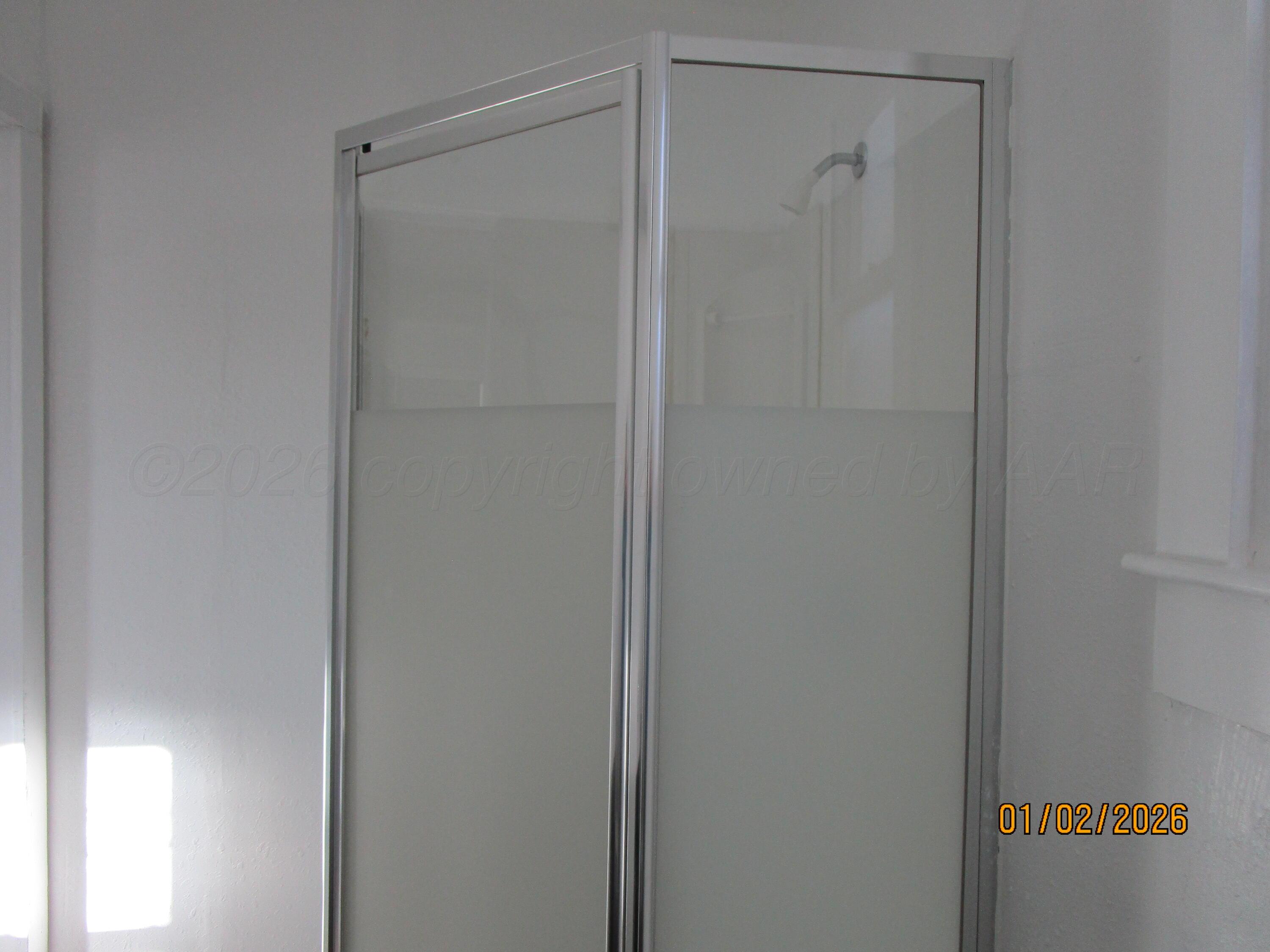 111 West Grand Street Borger, TX 79007 - Photo 6 of 6 a bathroom with a glass shower door