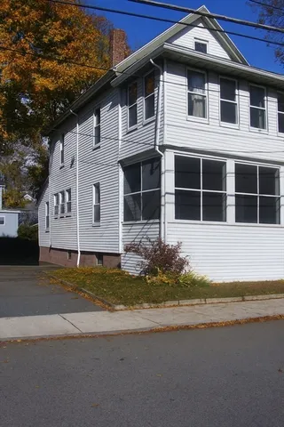 a house with a swimming pool in front of it