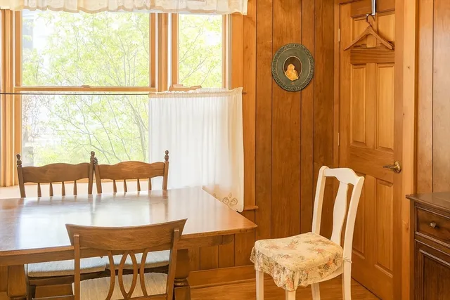 a view of a dining room with furniture and a window