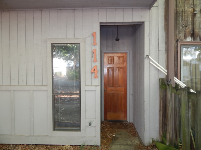 114 Houston Street Clemson, SC 29631 - Photo 2 of 2 A welcoming wooden front door with vertical siding awaits your arrival.