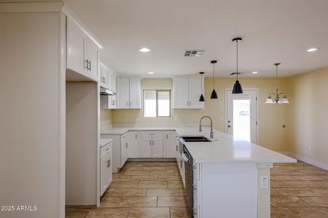 a kitchen with stainless steel appliances granite countertop a sink and cabinets
