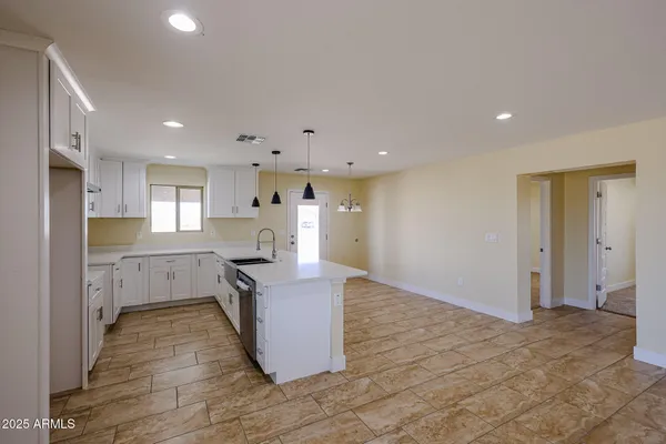 a kitchen with stainless steel appliances granite countertop a refrigerator and a stove