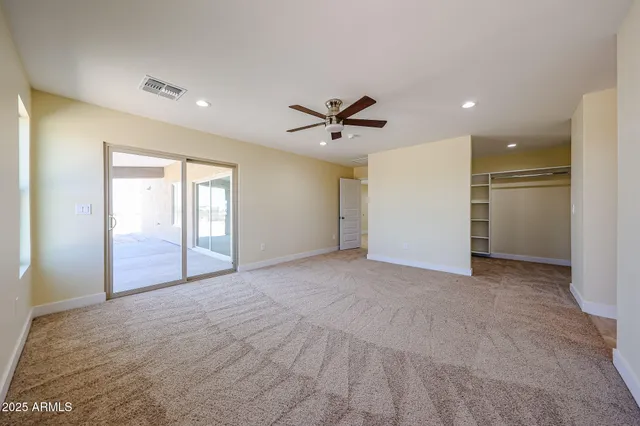 a view of a livingroom with a ceiling fan and window