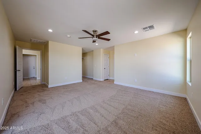 a view of an empty room with a ceiling fan