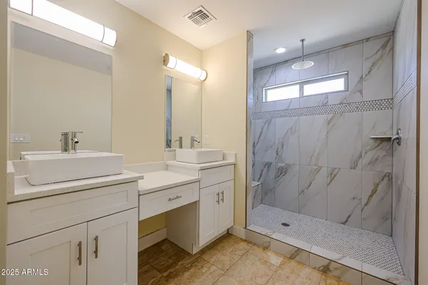 a bathroom with a shower sink and mirror