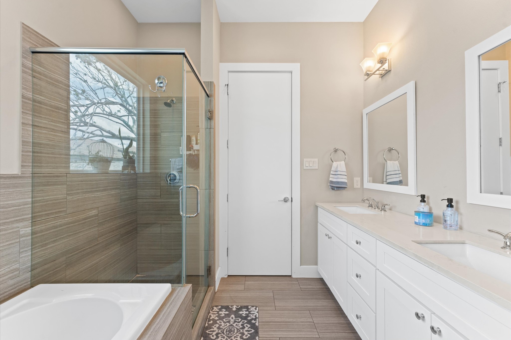 2422 Cochran Street Houston, TX 77009 - Photo 3 of 31 The primary suite, located on the 2nd floor, offers this elegant bath that includes a soaking tub, a separate shower, and a dual sink vanity.