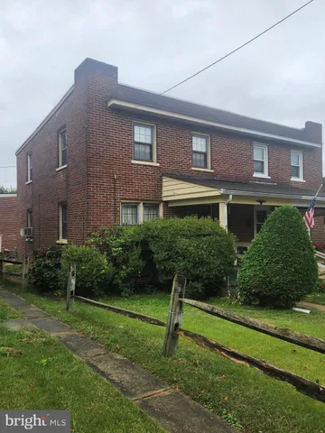 a brick building with a yard in front of it