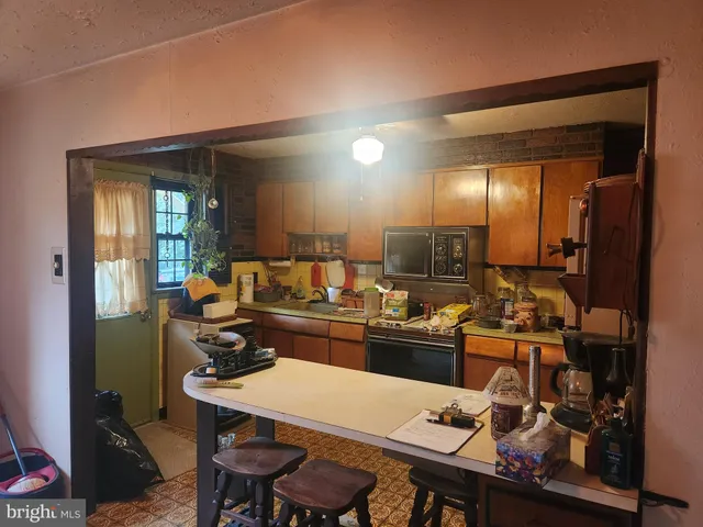 a kitchen with a table and chairs in it