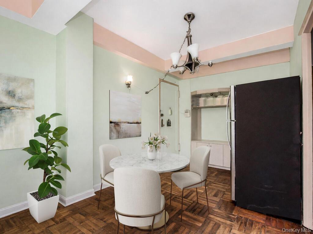 1521 Unionport Road, Unit 11A Bronx, NY 10462 - Photo 4 of 9 Dining area with baseboards and a chandelier