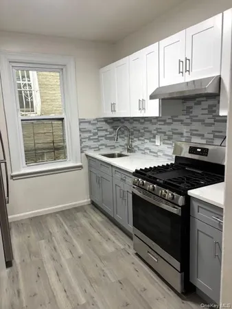a kitchen with a stove and a window