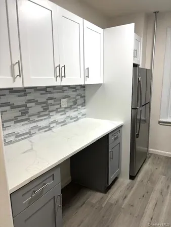 a kitchen with a sink and a refrigerator