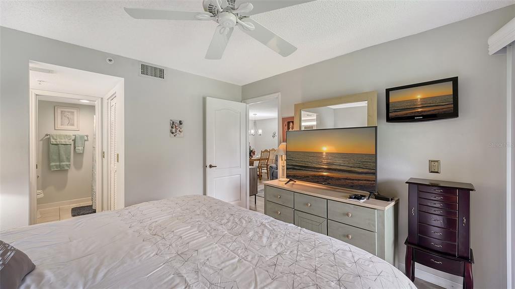 6505 Stone River Road, Unit 209 Bradenton, FL 34203 - Photo 19 of 47 a bedroom with a bed and a flat screen tv