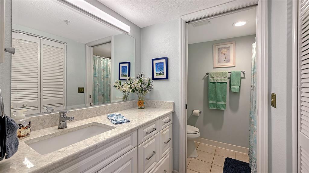 6505 Stone River Road, Unit 209 Bradenton, FL 34203 - Photo 20 of 47 a bathroom with a granite countertop sink and a mirror