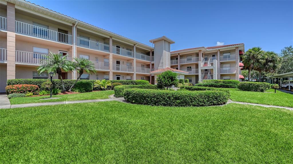 6505 Stone River Road, Unit 209 Bradenton, FL 34203 - Photo 2 of 47 a view of a building with garden