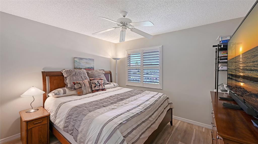 6505 Stone River Road, Unit 209 Bradenton, FL 34203 - Photo 21 of 47 a bedroom with a bed and a chandelier