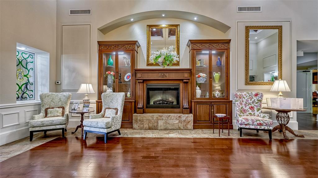 6505 Stone River Road, Unit 209 Bradenton, FL 34203 - Photo 33 of 47 a living room with furniture and a fireplace