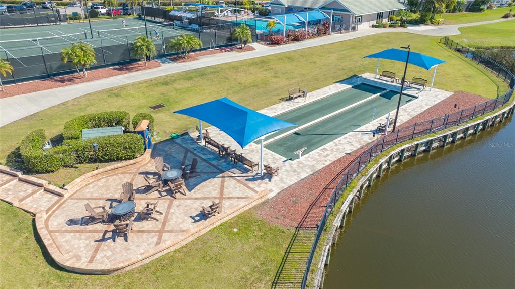 6505 Stone River Road, Unit 209 Bradenton, FL 34203 - Photo 41 of 47 a view of a swimming pool with a garden and seating area