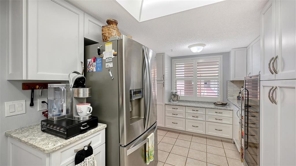 6505 Stone River Road, Unit 209 Bradenton, FL 34203 - Photo 8 of 47 a kitchen with stainless steel appliances a stove a refrigerator and cabinets