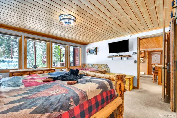 a kitchen with stainless steel appliances granite countertop a table chairs refrigerator and microwave