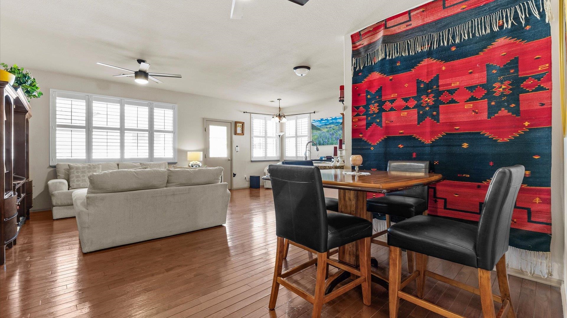 593 Sinatra Way Grand Junction, CO 81501 - Photo 11 of 23 a living room with furniture a chandelier and a floor to ceiling window