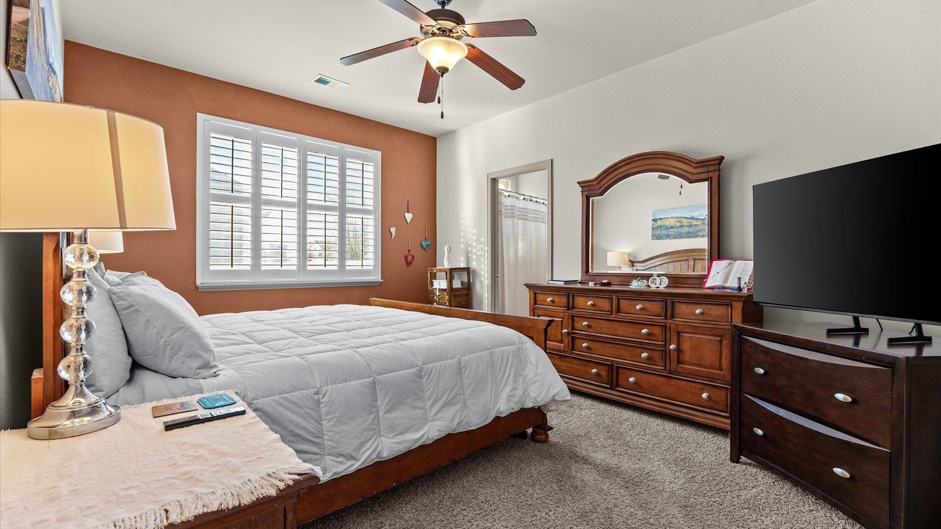 593 Sinatra Way Grand Junction, CO 81501 - Photo 12 of 23 a bedroom with a bed and a flat screen tv