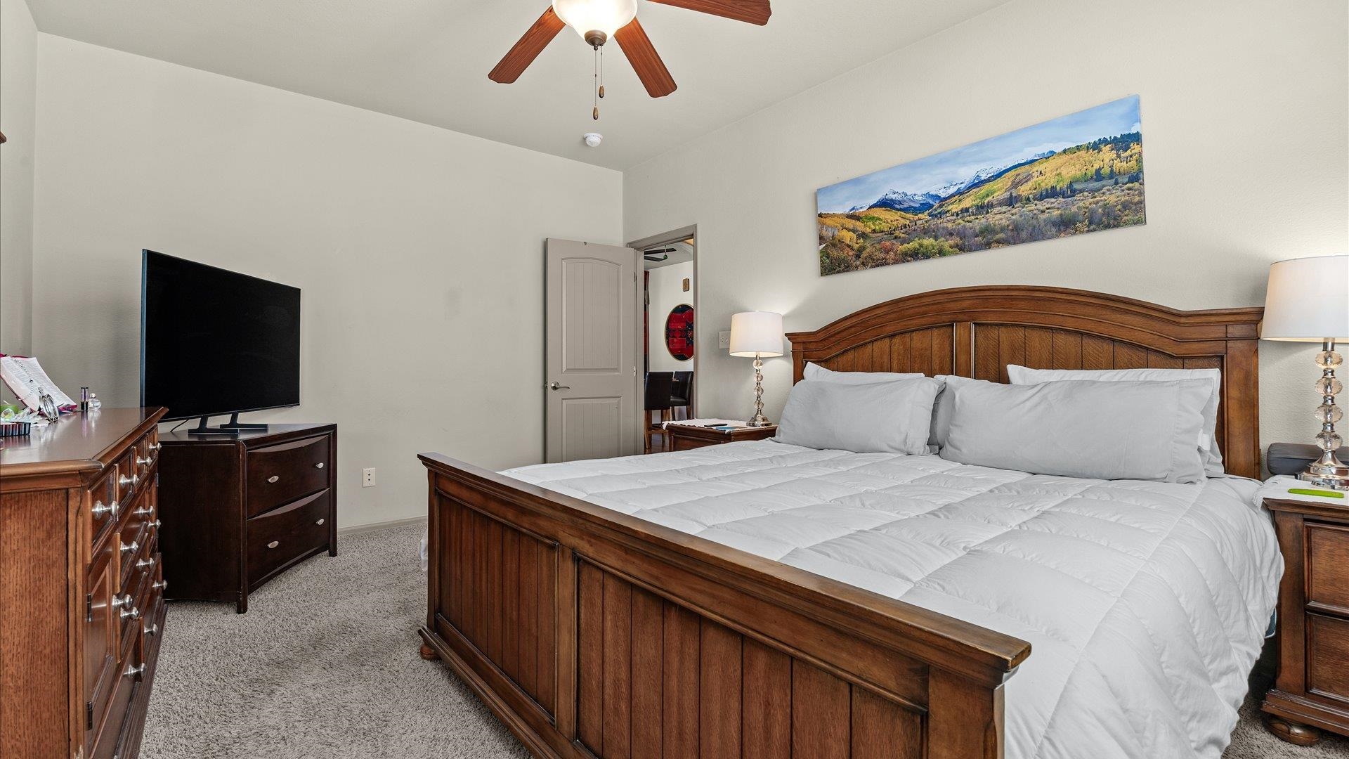 593 Sinatra Way Grand Junction, CO 81501 - Photo 13 of 23 a bedroom with a bed and a flat screen tv