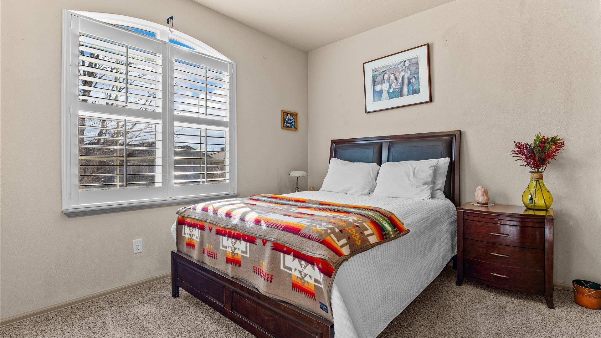 593 Sinatra Way Grand Junction, CO 81501 - Photo 16 of 23 a bedroom with a bed and a potted plant