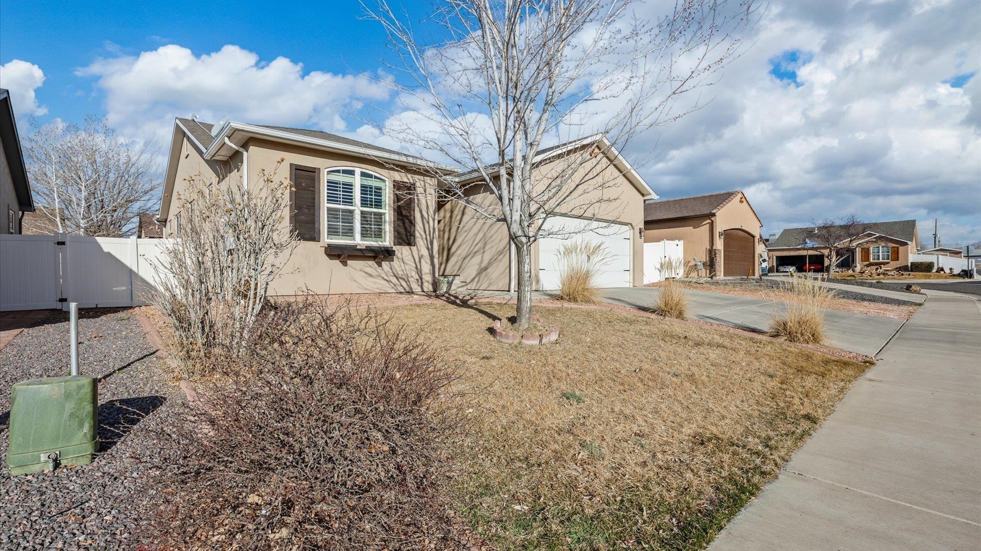 593 Sinatra Way Grand Junction, CO 81501 - Photo 2 of 23 a view of a yard in front of a house