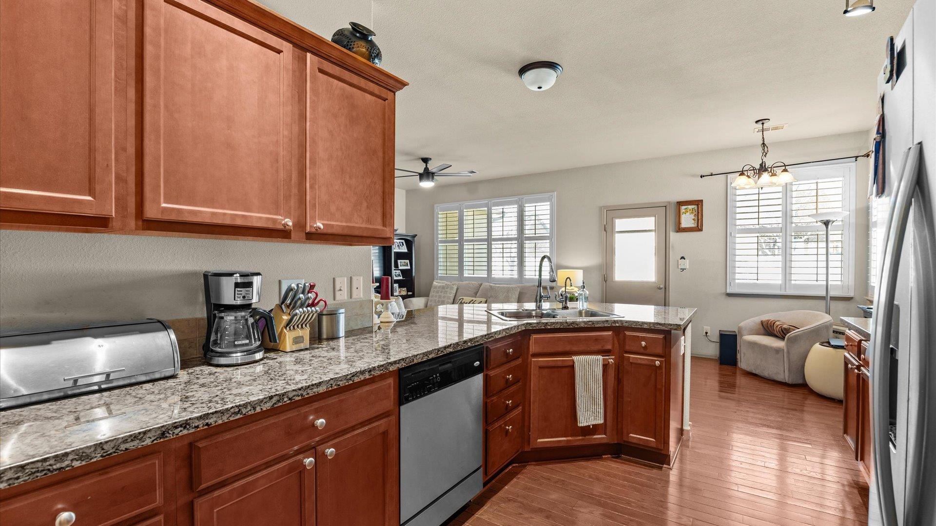 593 Sinatra Way Grand Junction, CO 81501 - Photo 9 of 23 a kitchen with granite countertop a sink dishwasher stove and cabinets