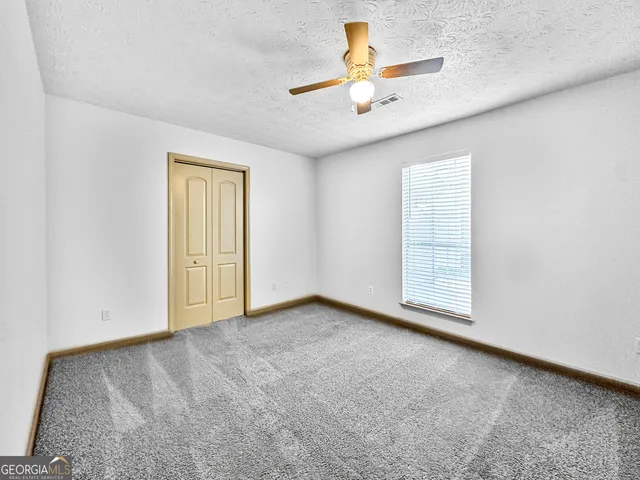 an empty room with a empty space and windows