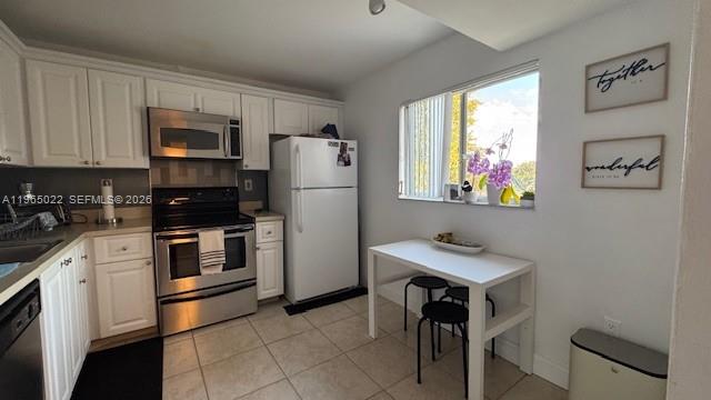 731 North Pine Island Road, Unit 306 Plantation, FL 33324 - Photo 3 of 13 a kitchen with stainless steel appliances a refrigerator and a stove top oven