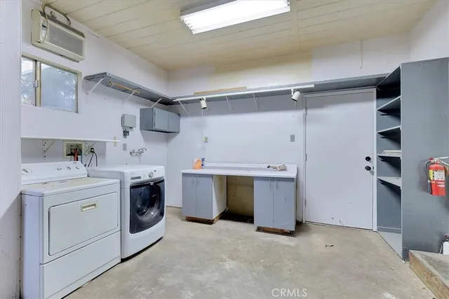 a utility room with cabinets dryer and washer