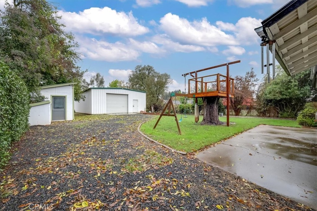 1291 East Chico, CA 95926 - Photo 21 of 29 a view of a house with a yard and table and chairs under an umbrella