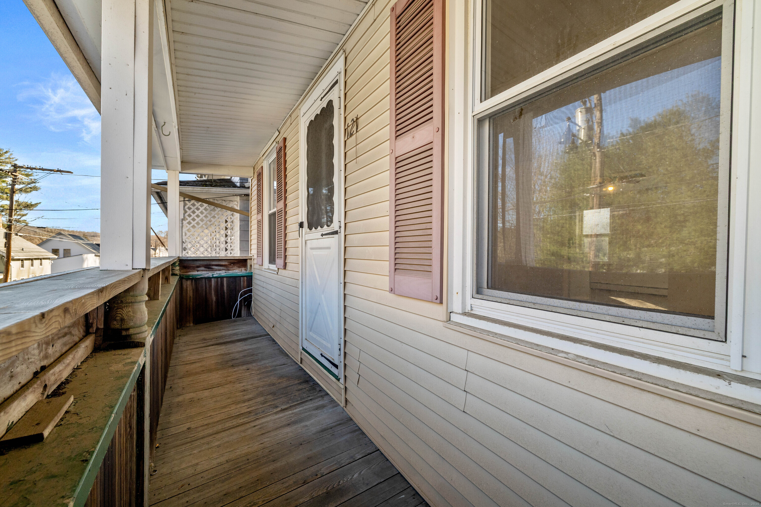 115 High Street Baltic, CT 06330 - Photo 18 of 37 a view of a balcony with wooden floor and iron stairs