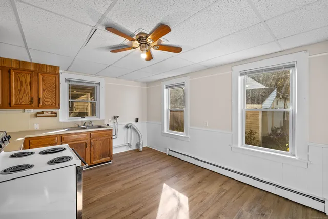 a view of a kitchen with a stove cabinets and a window