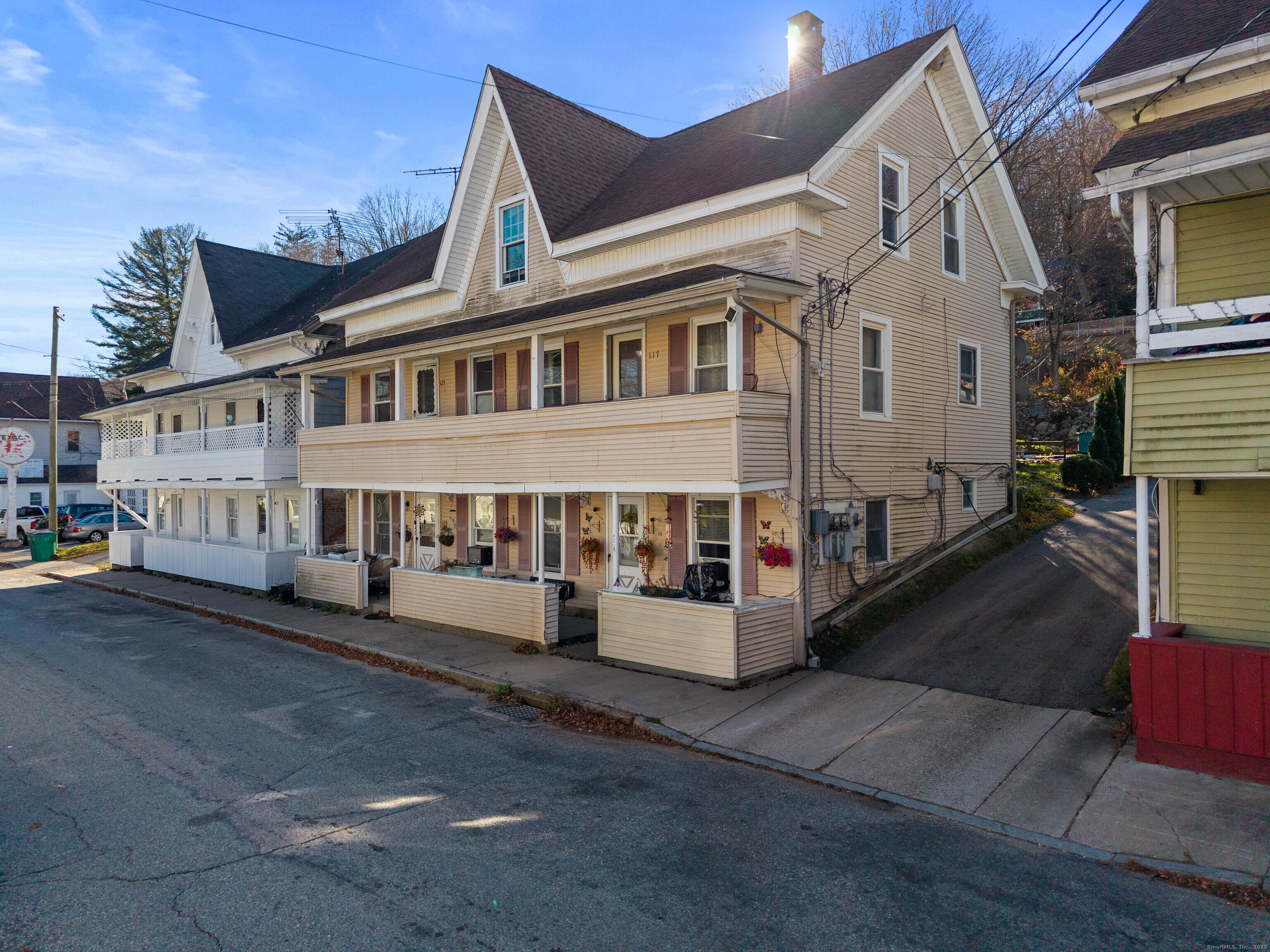 115 High Street Baltic, CT 06330 - Photo 2 of 37 a view of a white building among the street with outdoor seating