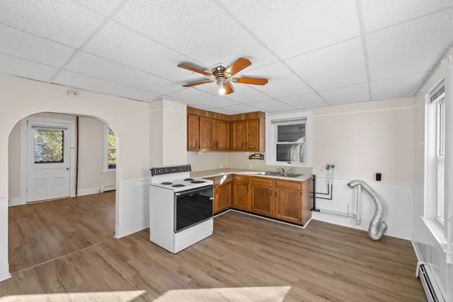 a kitchen with a stove a sink and a refrigerator