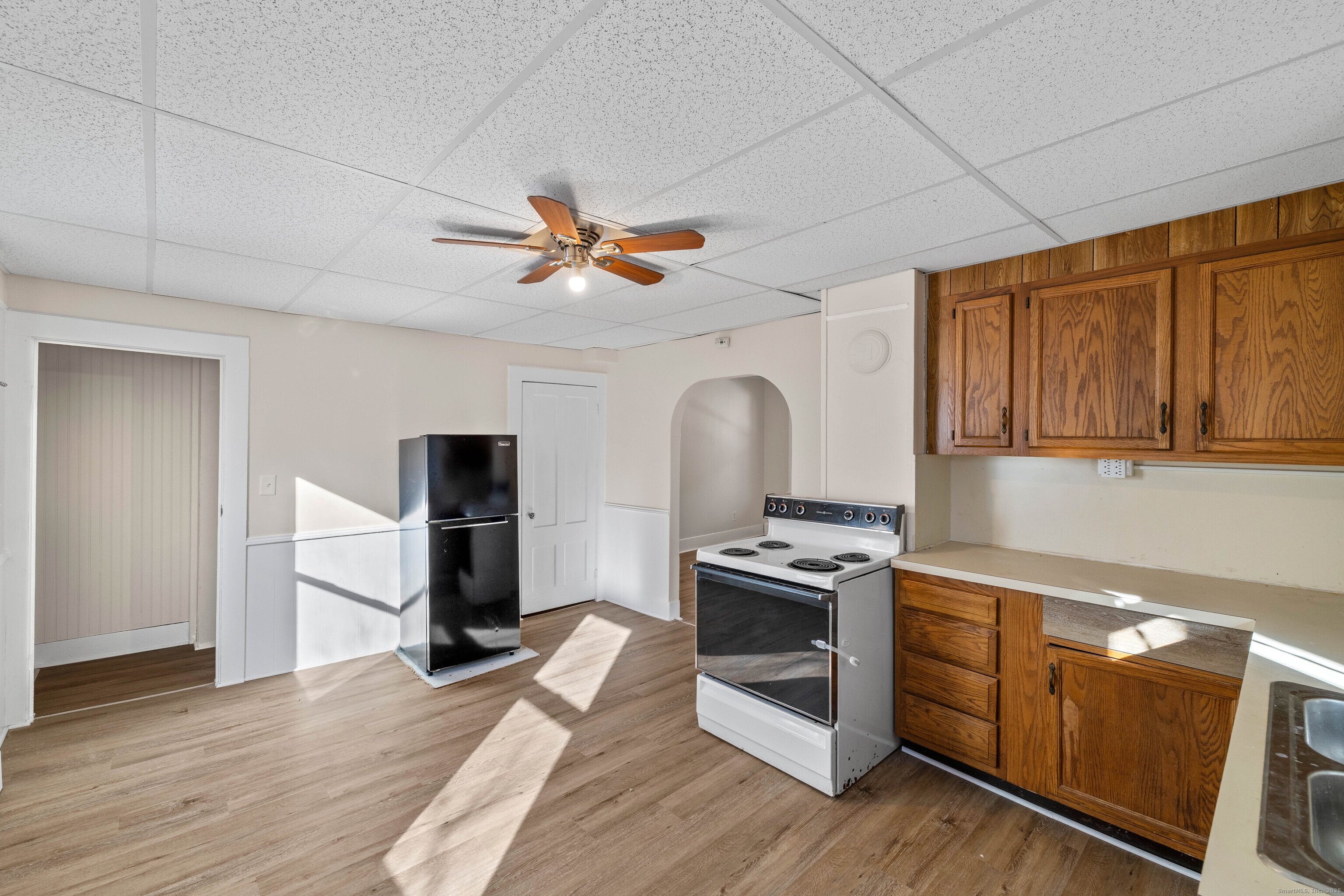 115 High Street Baltic, CT 06330 - Photo 22 of 37 a kitchen with a refrigerator and a stove top oven