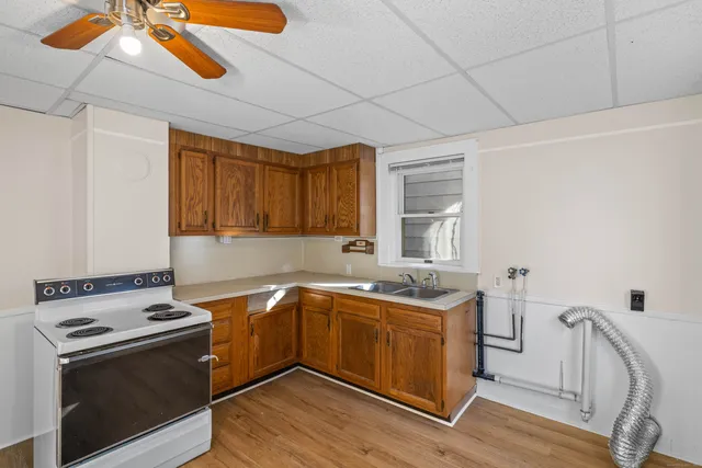 a kitchen with a stove sink and cabinets
