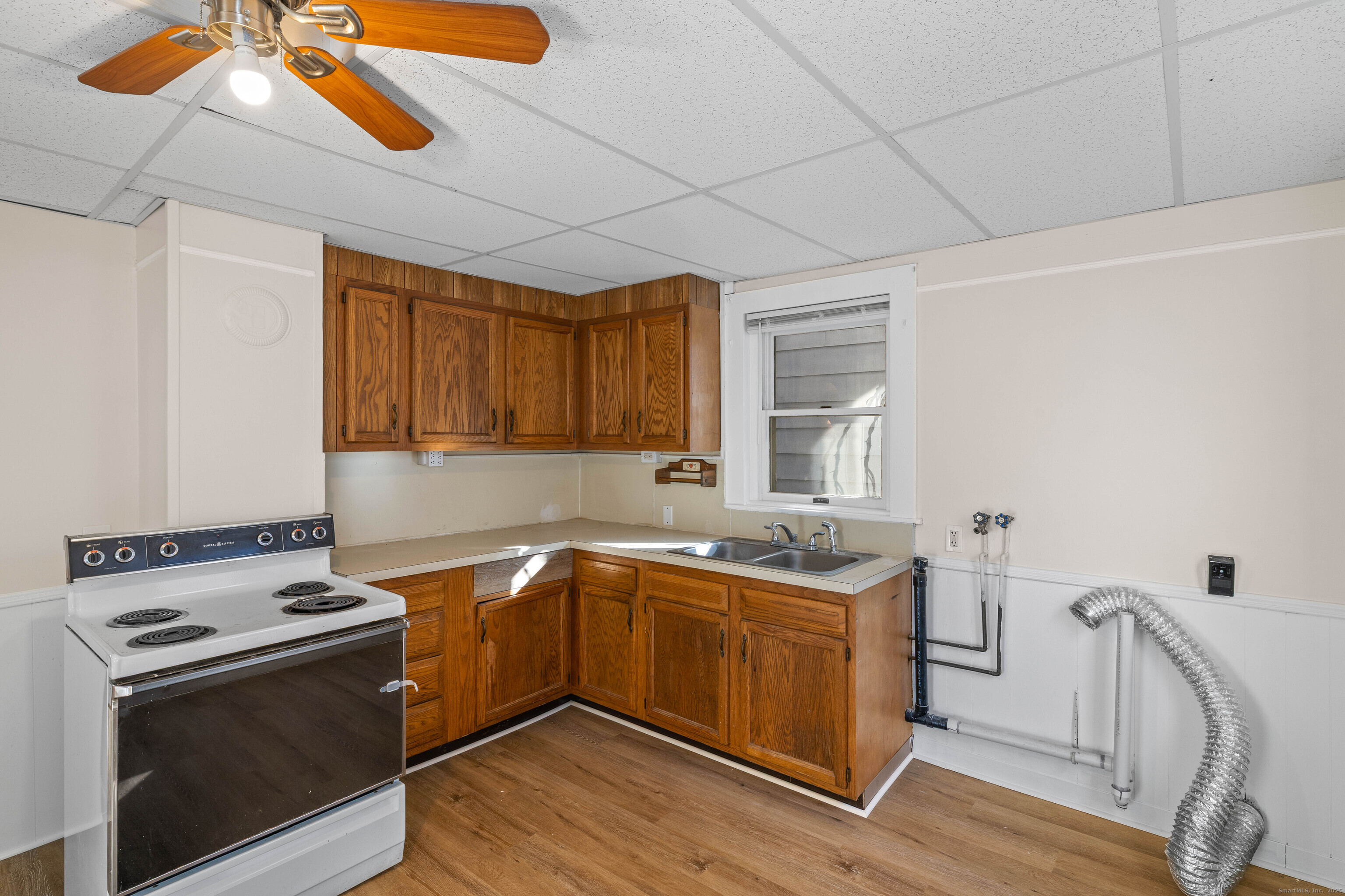 115 High Street Baltic, CT 06330 - Photo 23 of 37 a kitchen with a stove sink and cabinets
