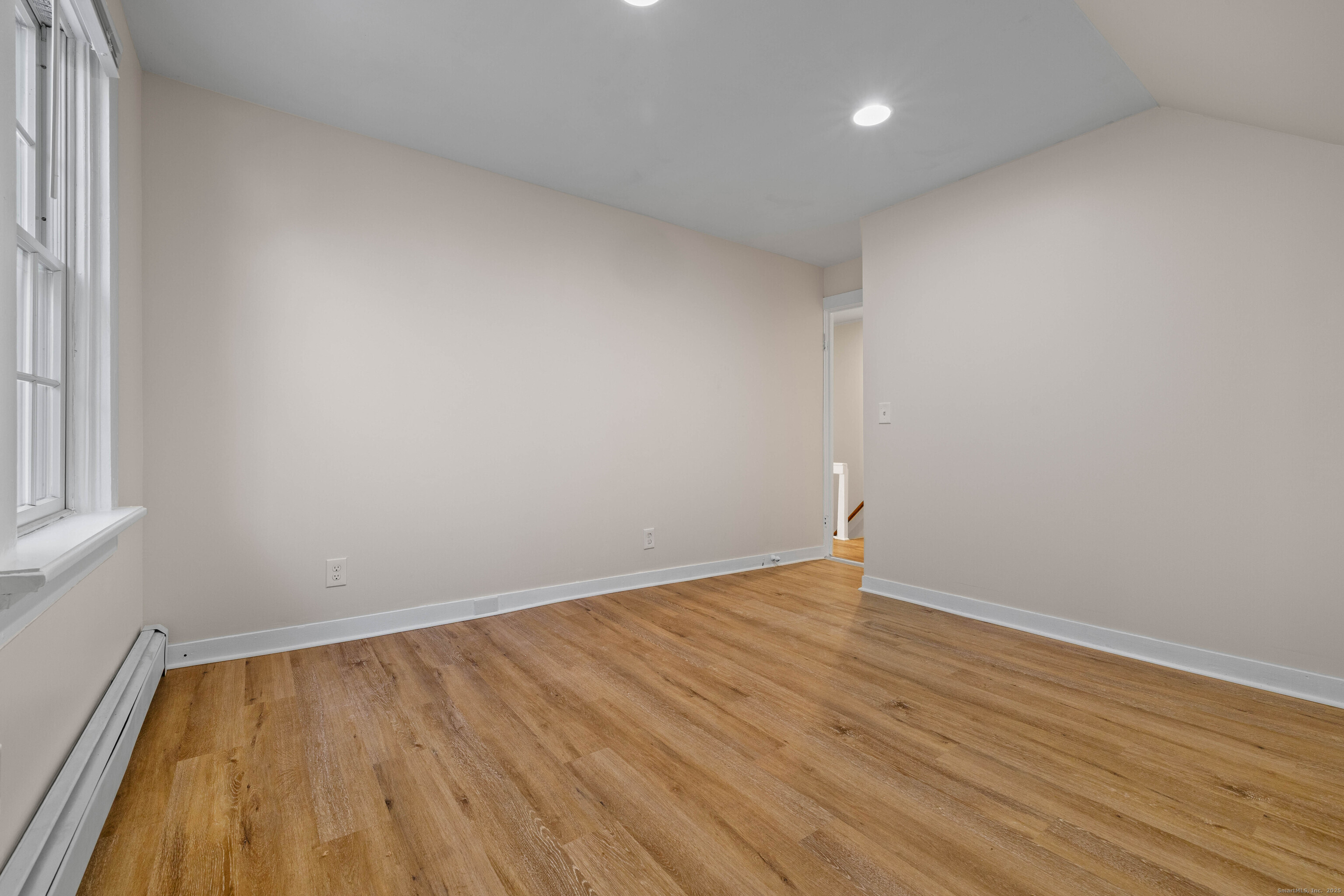 115 High Street Baltic, CT 06330 - Photo 28 of 37 an empty room with wooden floor and windows