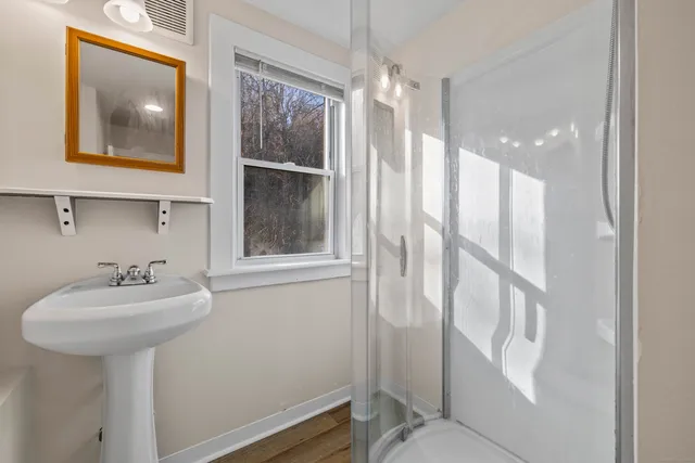 a bathroom with a sink mirror and toilet